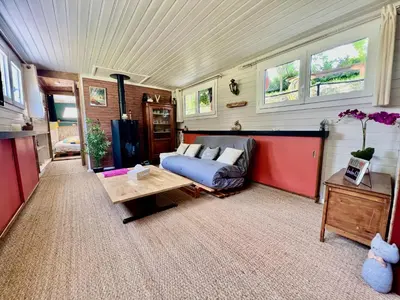 a living room with a couch and a table at Péniche Dondon - Gîte cocooning sur Canal du midi in Avignonet-de-Lauragais