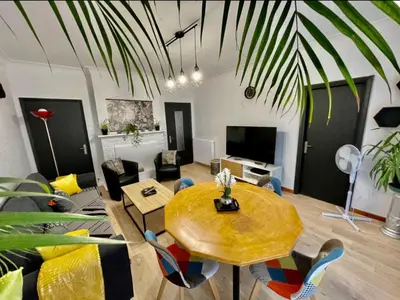 a living room with a table and a couch at Très grand appartement à 10 min à pied du centre in Castres