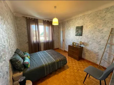 a bedroom with a bed and a desk and a chair at Très grand appartement à 10 min à pied du centre in Castres