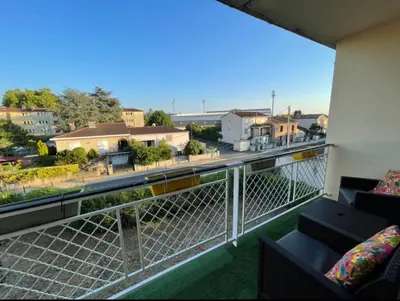 a balcony with couches and a view of a street at Très grand appartement à 10 min à pied du centre in Castres