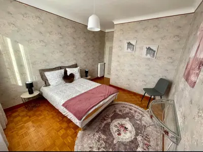 a bedroom with a bed and a chair at Très grand appartement à 10 min à pied du centre in Castres