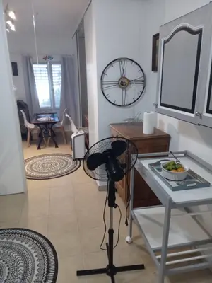 a room with a mirror and a table with a camera at Joli Studio avec jardin in Espira-de-lʼAgly