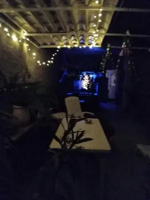 a room with a table and a chair and lights at Joli Studio avec jardin in Espira-de-lʼAgly