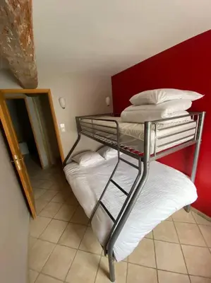 a room with a bedroom with a bed and a mirror at Gite a la ferme avec jacuzzi et sauna in Villefloure