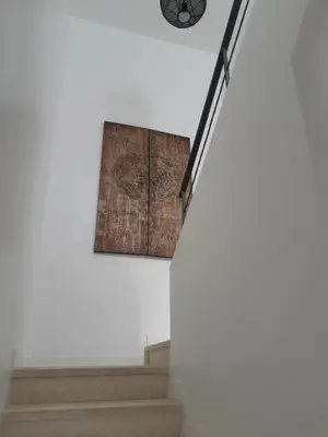 a clock hanging on a wall next to a staircase at Appartement fonctionnel proche du centre ville in Narbonne