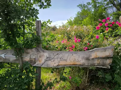 a wooden sign with the words for a love island cafe at Gite du grand cèdre in CampÃ´me