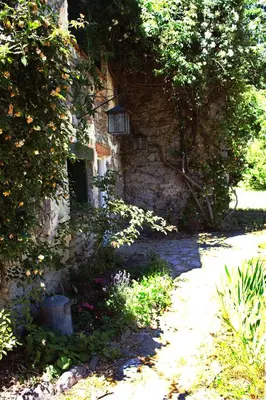 a stone building with a light on the side of it at Gite du grand cèdre in CampÃ´me