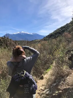 a woman walking up a hill with her head in the air at Gite du grand cèdre in CampÃ´me