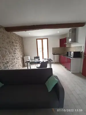a living room with a couch and a table at Porte Rouge in Capendu