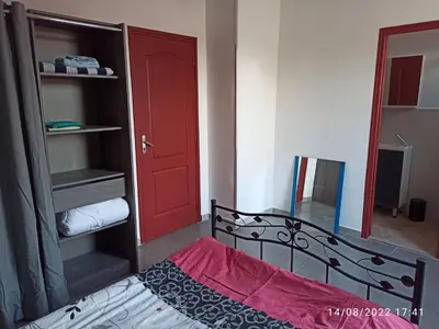 a bedroom with a bed with a red door at Porte Rouge in Capendu