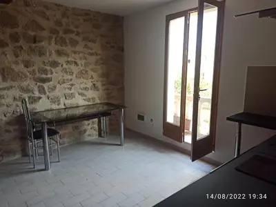 a dining room with a table and a window at Porte Rouge in Capendu