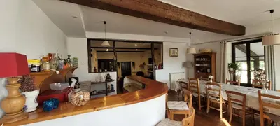 a dining room with a table and some chairs at Grande maison de montagne rénovée, du charme in Rodome