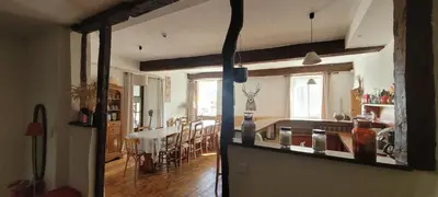 a kitchen and a living room with a dining room at Grande maison de montagne rénovée, du charme in Rodome