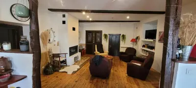 a living room with a couch and chairs in it at Grande maison de montagne rénovée, du charme in Rodome