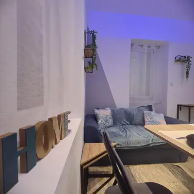 a living room with a couch and a table at Très joli appartement 2 pièces, centre-ville in Tuchan