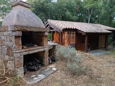 an outdoor oven with a building in the background at GITE DE KATE in Albières