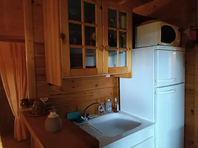 a kitchen with a white refrigerator and a microwave at GITE DE KATE in Albières