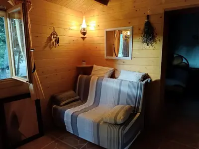a room with a bed in a log cabin at GITE DE KATE in Albières