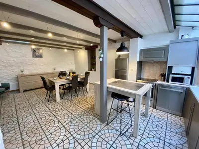 a kitchen with a table and chairs in a room at Le Gîte du Canal, à Homps. in Homps