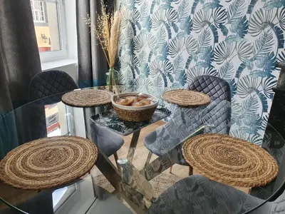 a glass table with four chairs and a glass tableasteryasteryasteryasteryasteryastery at A l ombre des remparts 3 in Carcassonne