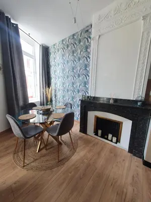 a living room with a table and a fireplace at A l ombre des remparts 3 in Carcassonne
