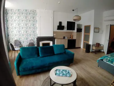 a living room with a blue couch and a table at A l ombre des remparts 3 in Carcassonne