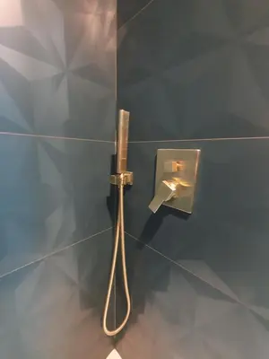 a shower in a glass wall with a toothbrush at A l ombre des remparts 3 in Carcassonne