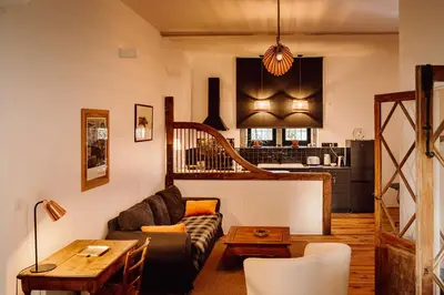 a living room with a couch and a table at Gîte Superbe L'Ecurie XIXème in Sallèles-dʼAude
