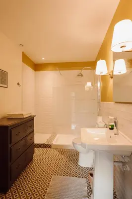 a bathroom with a sink and a toilet and a tub at Gîte Superbe L'Ecurie XIXème in Sallèles-dʼAude