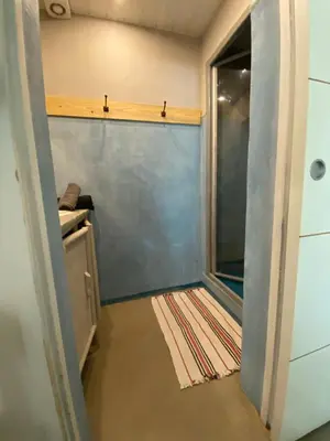 a walk in shower in a small room with a glass door at Joli gîte chic et cosy entre mer et Narbonne in Narbonne