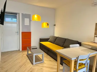 a living room with a couch and a table at Appartement Terrasse proche centre et canal in Narbonne