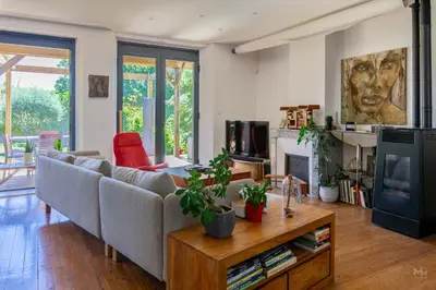 a living room with a couch and a table at Maison, piscine & vue sur la Cité de Carcassonne in Carcassonne