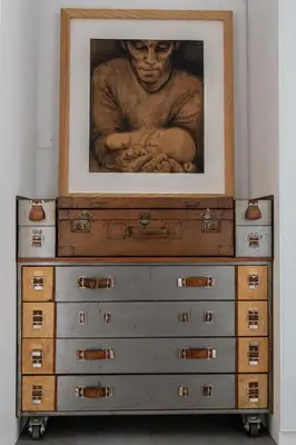 a painting on top of a dresser with drawers at Maison, piscine & vue sur la Cité de Carcassonne in Carcassonne