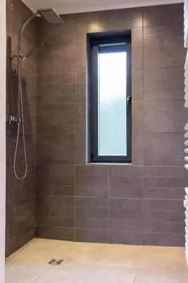 a bathroom with a shower and a window at Maison, piscine & vue sur la Cité de Carcassonne in Carcassonne