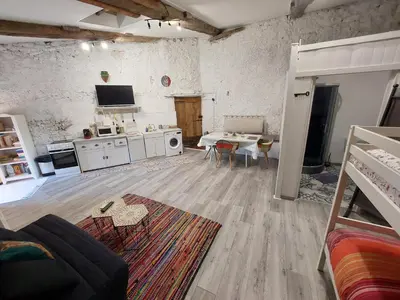 a living room with a kitchen and a dining room at Gite Studio Les Maisons de Gaïa in Tuchan