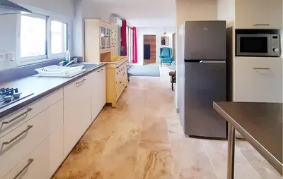 a kitchen with a stainless steel refrigerator and a counter at Awesome Home In Villeneuve-Lès-Montréa in Villeneuve-lès-Montréal