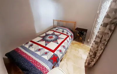 a bed with a quilt on it in a room at Awesome Home In Villeneuve-Lès-Montréa in Villeneuve-lès-Montréal