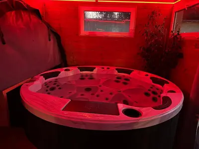 a red bathtub in a red room with a window at Gîte Ardoise in Castelnaudary