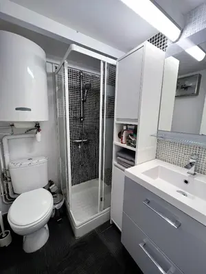 a bathroom with a shower and a toilet and a sink at La maisonnette de Gruissan in Gruissan