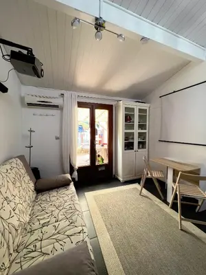 a living room with a couch and a table at La maisonnette de Gruissan in Gruissan