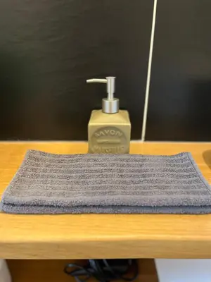 a close up of a soap dispenser on a table at SalutBB Chambre d'hote in Carcassonne