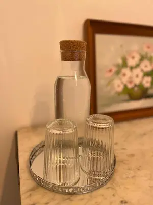 a bottle of milk and two glasses on a table at SalutBB Chambre d'hote in Carcassonne