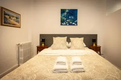 a bedroom with a bed with two towels on it at SalutBB Chambre d'hote in Carcassonne