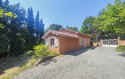 a small house sitting on a gravel driveway at Awesome Home In Ferrières-Poussarou in Ferrières-Poussarou