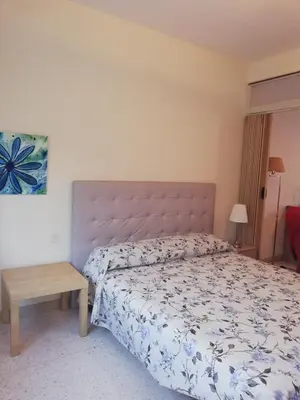 a bedroom with a large bed and a table at Chez Mi, centre ville, parking gratuit in Saint-Chinian