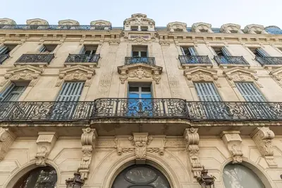 a building with a balcony on the side of it at The Gatsby room - 50m des halles - Design avec ascenseur in Narbonne