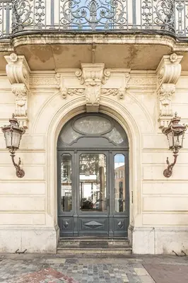 an entrance to a building with a black door at The Gatsby room - 50m des halles - Design avec ascenseur in Narbonne