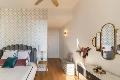 a bedroom with a bed and a couch at The Gatsby room - 50m des halles - Design avec ascenseur in Narbonne