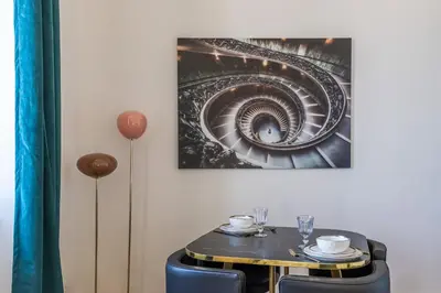 a table with a picture of a spiral staircase at The Gatsby room - 50m des halles - Design avec ascenseur in Narbonne
