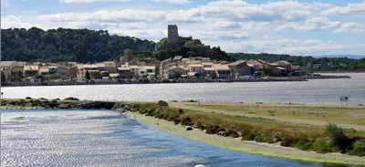 a body of water with a town in the background at Appartement T2 Gruissan port, rive gauche in Gruissan